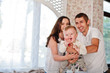 © AS Photo Family - Cute caucasian baby boy laughs on arms of parents