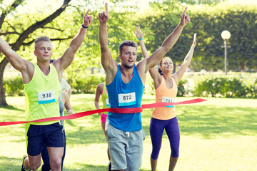 Canvas Print - happy young male runner winning on race finish