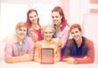 © Syda Productions - smiling students with blank tablet pc screen