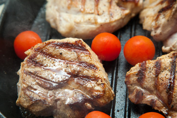 Grilled bbq steaks with fresh herbs and tomatoes