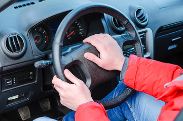 Man's hand hold drive in car close up