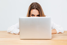 Young Brunette Woman Hiding Behind Her Laptop