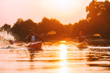 Wall Mural - Couple kayaking together. 