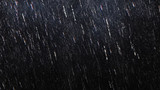 Fototapeta  - Falling raindrops footage animation in slow motion on dark black background with fog, lightened from top, rain animation with start and end, perfect for film, digital composition, projection mapping