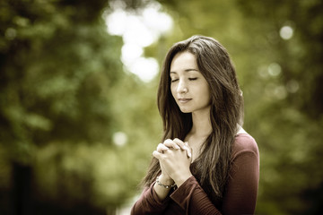 Wall Mural - Woman praying outdoors