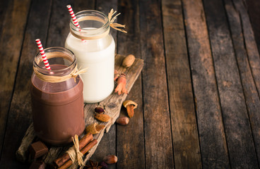 Wall Mural - Chocolate and vanilla milkshake in the glass jar 