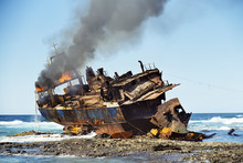 Stranded Fish Cutter Lying Burning At A Reef.