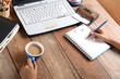 © ruksil - A woman works on a computer desk, book, books, pencils, DVD and coffee table.