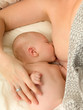 Closeup breastfeeding in bed