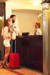 © Kalim - Family checking in hotel