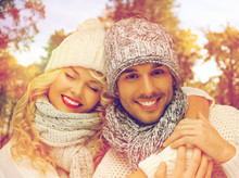 Happy Couple In Warm Clothes Over Autumn