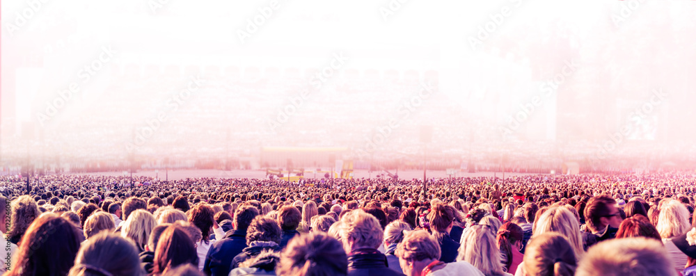 Panoramic photo of large crowd of people. Slow shutter speed with motion blur. - obrazy, fototapety, plakaty 