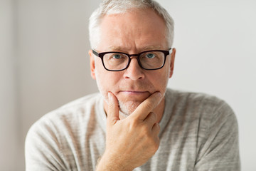 Sticker - close up of senior man in glasses thinking