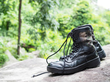 Combat Boots After The Heavy Duties In The Army Work, Symbol Of Soldier And Green Nature And Waterfall, Concept Of Strong And Confidence, Adventure Sign And Symbol.