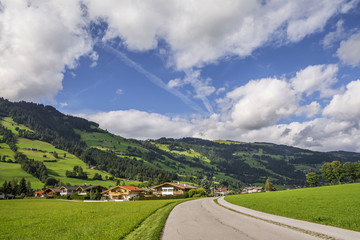 Wall Mural - Country road in Brixental Valley in Tirolean Alps, Austria, popular summer and winter location for tourism .