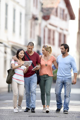 Wall Mural - Young people on vacation walking in city street