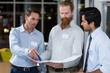 © WavebreakmediaMicro - Businessmen discussing over blueprint