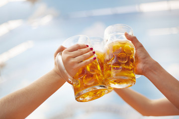 Raised beer steins toasting at Oktoberfest