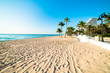 White sand deserted Fort Lauderdale South Florida beach stretching out under beautiful blue cloudless sky
