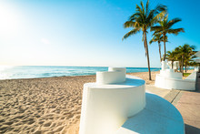 Deserted Fort Lauderdale South Florida Beach With Iconic Spiral Wall And Palm Trees Under Brilliant Blue Sky
