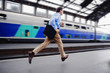 © Eric Hood - Rushed businessman running through railway station to catch last train