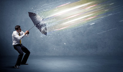 Wall Mural - Business man defending light beams with umbrella concept