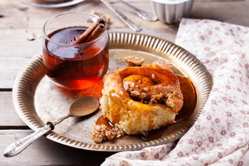 cinnamon bun rolls with syrup and tea