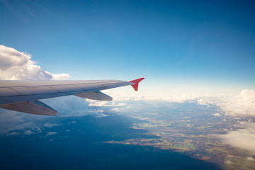 Wall Mural - aircraft wing flying over clouds