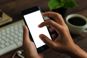 Wall Mural - closeup hand use phone showing white screen on work desk, blank