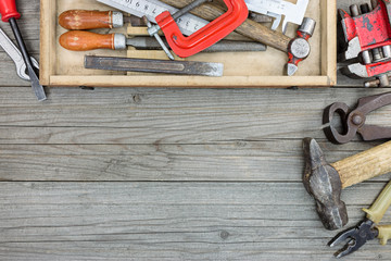 Wall Mural - old tool set of rusty hammer, nipper, clamps wrenches and other instruments in toolbox on wooden background