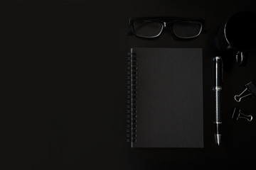 Black notebook with copyspace and cup of coffee