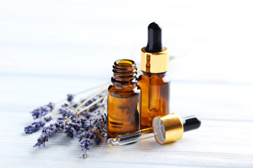 Wall Mural - Lavender oil and flowers on white wooden table