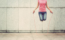Young Fitness Woman Jumping Rope Outdoor