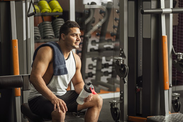 Wall Mural - Optimistic delighted man resting after an intensive workout