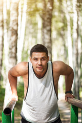 Wall Mural - Pleasant nice sportsman working out outdoors