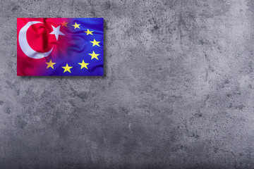 Wall Mural - Flags of the Turkey and the European Union on concrete background.