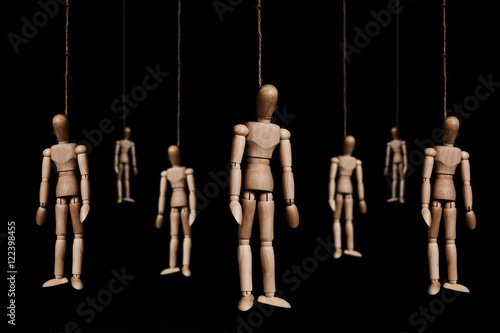Fotografie, Obraz Low key, wooden figures hangman by rope, on black background
