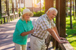 © DenisProduction.com - Senior male leans on fence. Elderly couple outdoors. Pains in lower back. Old traumas influence health.