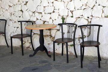 Sticker - old chairs and white stone antique wall in greek village