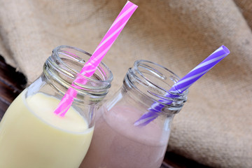 Canvas Print - Bottles with chocolate and banana milkshake