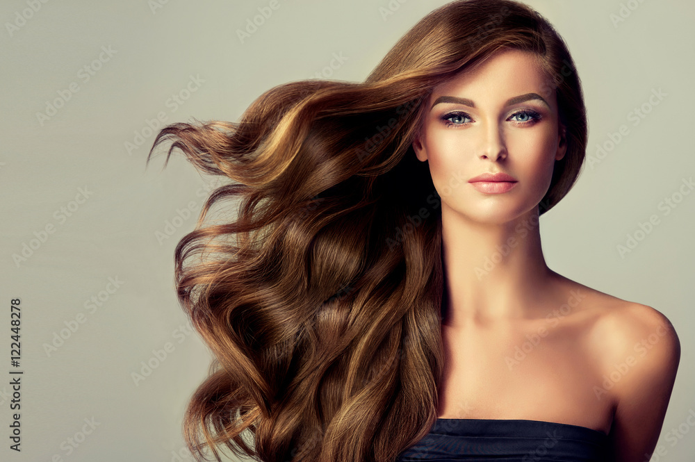 Beautiful model  girl with long wavy  and shiny  hair . Brunette woman  with curly hairstyle  - obrazy, fototapety, plakaty 