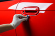 Car detailing series : Closeup of hand coating red car door