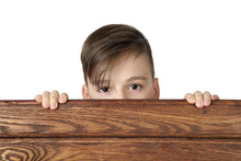 Cute Handsome Boy Peeking From Behind Wooden Fence Isolated On White Background