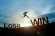 Silhouette of businessman glowing jump Lose to Win. success conc