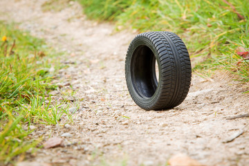 Black rubber tire rolling on the ground.