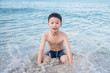 © gamelover - Young asian boy playing on the beach