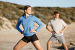 © Sergey Nivens - Young couple on beach training together