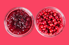 Lingonberry Jam And Lingonberries In Glass Bowls Over Pink. Fresh Red Fruits Of Vaccinium Vitis-idaea, Also Mountain Cranberries, Partridgeberries Or Cowberries. Staple Food In Scandinavian Cuisine.