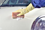 Fototapeta Przestrzenne - Male hand washing a white car