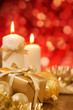 Christmas scene with gold baubles, gift and candles